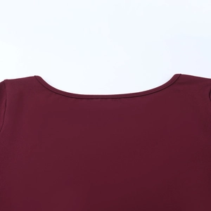 Detail shot of the burgundy round neckline with neat stitching on the slimming lace dress