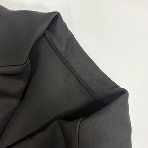 Close-up of premium stitching and lapel texture on black long sleeve blazer dress