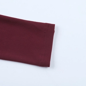 Detailed view of dark wine red knit sleeve cuff with precise double needle stitching