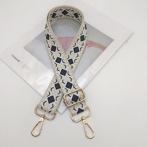 Detail of diamond pattern wide strap with gold adjustment buckle and lobster clasp