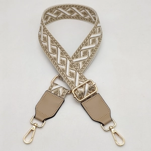 Detail view of adjustable wide woven shoulder strap with geometric diamond pattern