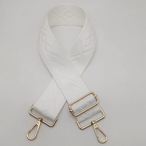 Detail of adjustable 5cm wide white canvas strap with gold metal hooks and geometric weave