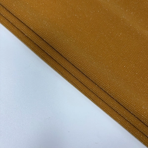 Detail of ginger mesh fabric with shimmering glitter and metallic fiber texture