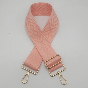 Detail of adjustable 5cm wide pink orange woven shoulder strap with gold metal buckles