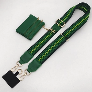 Detail of adjustable woven green and yellow geometric strap with a mini zipper pouch