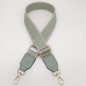 Adjustable sage green canvas shoulder strap with gold metal buckles for crossbody bags