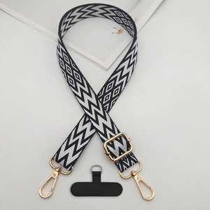 Adjustable black and white woven phone strap with gold hardware and d-ring patch