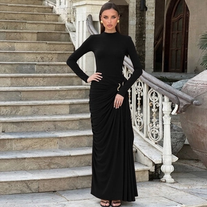 Detail view of waist ruched pleats and metallic ring decoration on black long sleeve dress