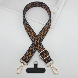 Adjustable crossbody phone strap with black and brown geometric jacquard pattern and gold clips