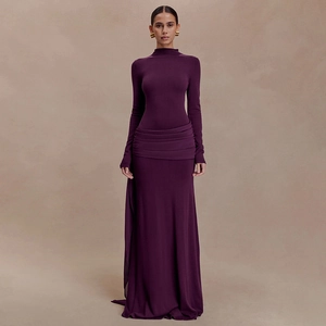 Close-up of elegant pleated waist detail on this slim fit dark purple maxi dress