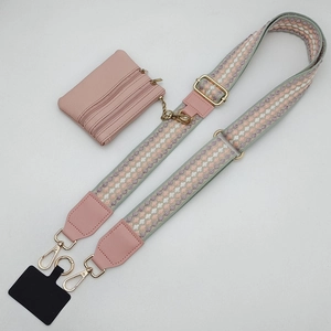 Polka dot jacquard shoulder strap with pink zipper pouch and phone patch kit