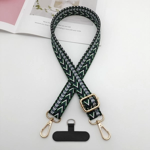 Détail de la bandoulière tissée géométrique avec boucles dorées et patch téléphone