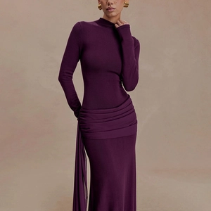 Detail of elegant dark purple long-sleeved dress featuring waist pleats and side ribbons