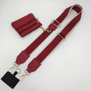 Detail of burgundy adjustable phone strap with matching mini coin purse and gold hardware