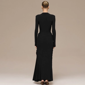 Close-up of the back view of a slim-fit black long-sleeve dress with ruched side details