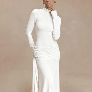 Detail of elegant white long sleeve dress showing chic waist pleats and draped side panel