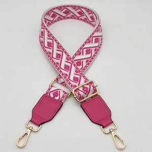 Adjustable geometric jacquard woven bag strap with pink leather and gold metal clips