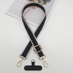 Detail of adjustable blue woven phone strap with gold metal buckle and patterned fabric