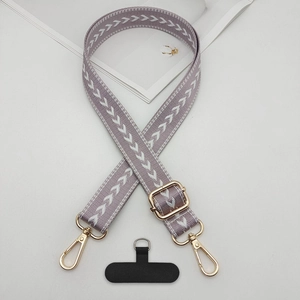 Macro view of adjustable lilac woven phone lanyard with golden metal hardware and strap card