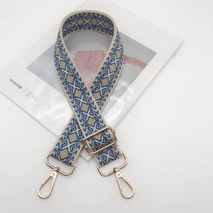Close-up of diamond pattern strap with light gold metal lobster clasps and adjuster