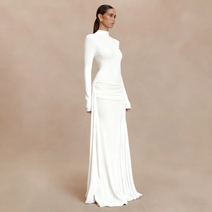 Detail of the white long sleeve dress showing side pleats and flowing drape detail
