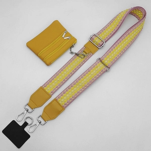 Polka dot phone strap with a mini yellow crossbody bag and adjustable woven shoulder strap
