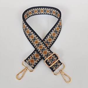 Detail of adjustable geometric strap with gold hooks for crossbody and shoulder bags