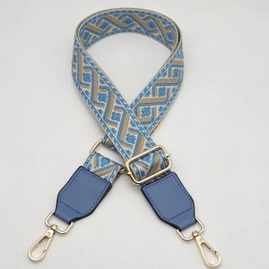 Close-up of adjustable light blue jacquard strap with gold hardware and rotating hooks