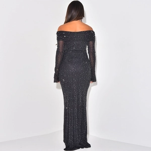 Close-up of black off-shoulder maxi dress featuring shimmering silver glitter fabric