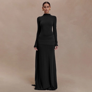Detailed view of elegant waist pleats and drapes on this black long-sleeved evening dress