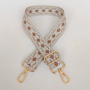 Close-up of geometric diamond woven shoulder strap with gold-tone metal lobster clasps