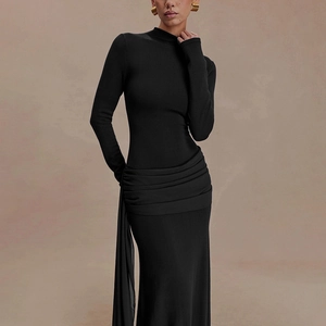 Detail of elegant black slim dress with unique waist pleats and flowing long streamer design