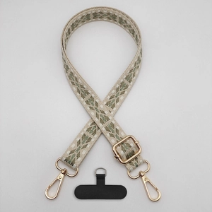 Detail of vintage geometric plaid phone strap with gold adjustable buckle and hook