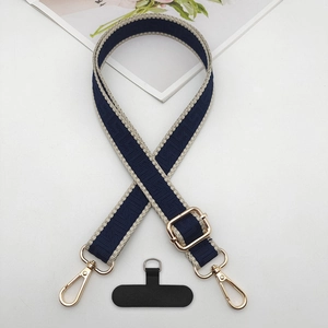 Detail of adjustable jacquard phone strap with navy geometric pattern and gold alloy hooks