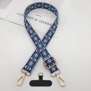 Detail of adjustable ethnic jacquard phone strap with gold hardware and fixing patch
