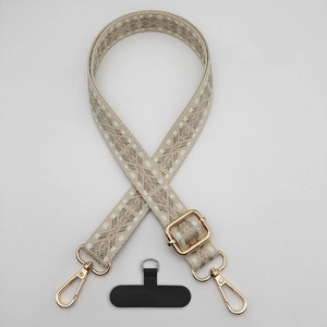 Detail view of retro geometric diamond pattern phone strap with gold metal hooks