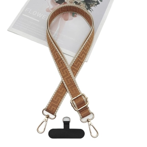 Adjustable brown geometric jacquard woven phone strap with gold hooks and gasket