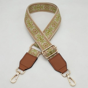 Detail showing the floral woven texture and golden metal buckle of this vintage wide strap
