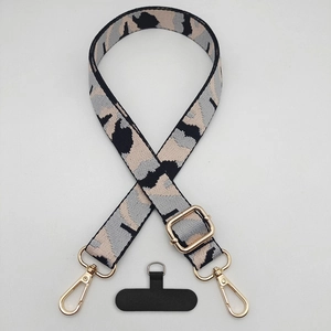 Macro shot of leopard pattern strap with golden metal hooks and adjustable buckle