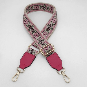 Detail of bohemian floral wide strap with pink leather and light gold metal buckle