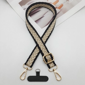 Close-up of adjustable woven phone strap with gold hardware and herringbone pattern