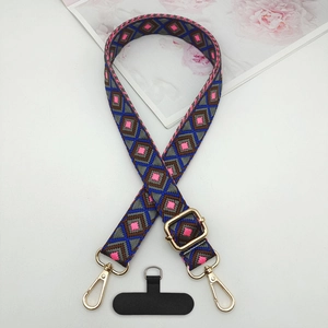 Close-up of ethnic geometric diamond pattern woven phone strap with gold lobster clasps