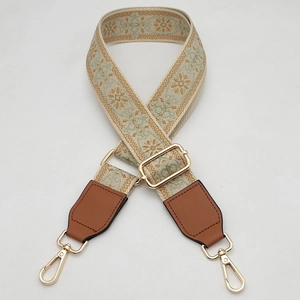 Detail of adjustable floral strap with gold lobster clasp and brown leather ends