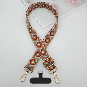 Detail of adjustable crossbody phone strap with geometric diamond pattern and metal hooks