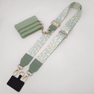Detail of green leopard print wide strap with mini coin purse and gold metal hooks