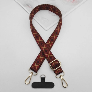 Detail of adjustable ethnic geometric pattern phone strap with gold metal buckle and connector