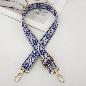 Adjustable blue and white embroidered guitar style bag strap with gold metal hardware