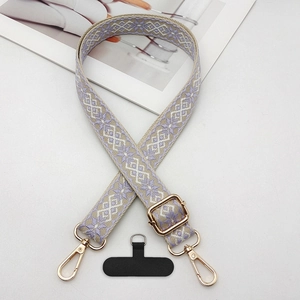Detail of lavender geometric jacquard phone strap with gold metal buckle and lobster clasp