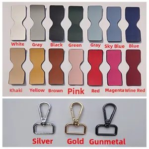 Dettaglio di toppe in pelle colorate e ganci in metallo oro, argento e canna di fucile