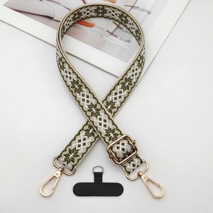 Close-up of olive green ethnic pattern phone strap with gold hooks and connector pad